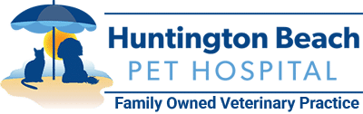 Logo for Huntington Beach Pet Hospital featuring a cat and dog sitting under a beach umbrella with a sun in the background. Text reads: "Huntington Beach Pet Hospital - Family Owned Veterinarian Practice.”.