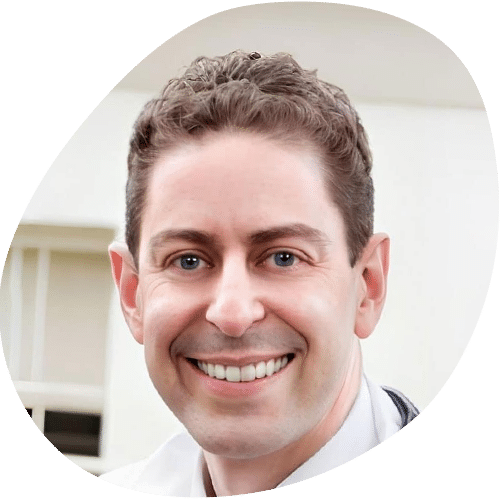 Smiling male doctor in white coat headshot