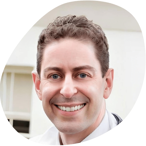 Smiling male doctor in white coat headshot